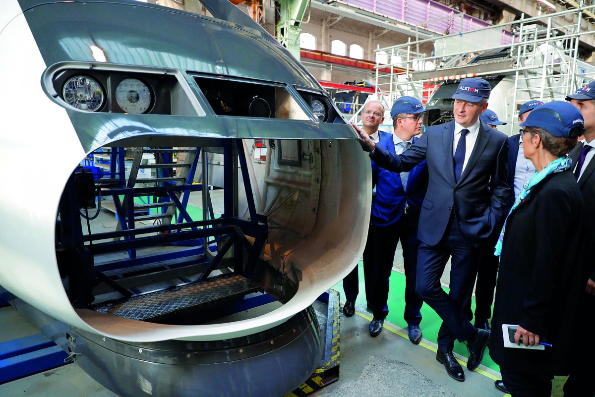 French Finance Minister Bruno Le Maire stands next to a high-speed train TGV as he visits the Alstom factory in Belfort, France, October 26, 2017. Reuters/Philippe Wojazer