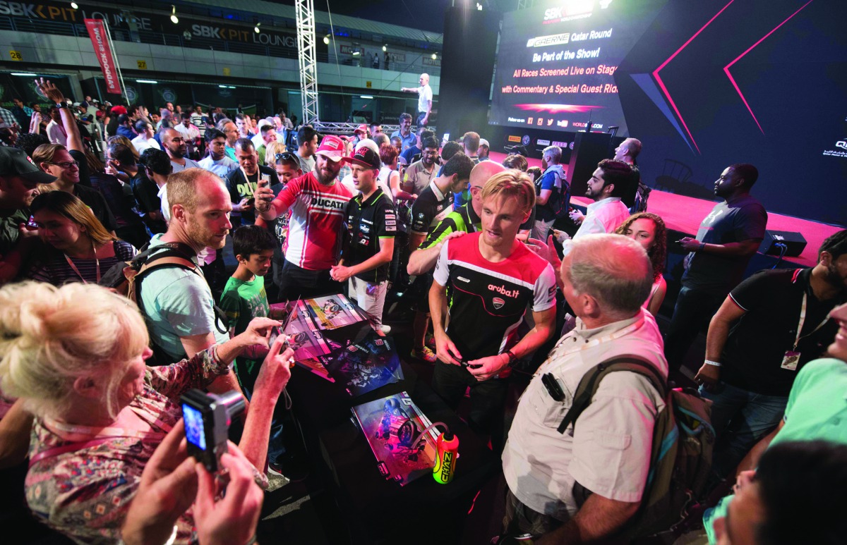 Riders interact with fans during the Qatari leg of the FIM Superbike World Championship 2016 at Losail International Circuit in this file photo.