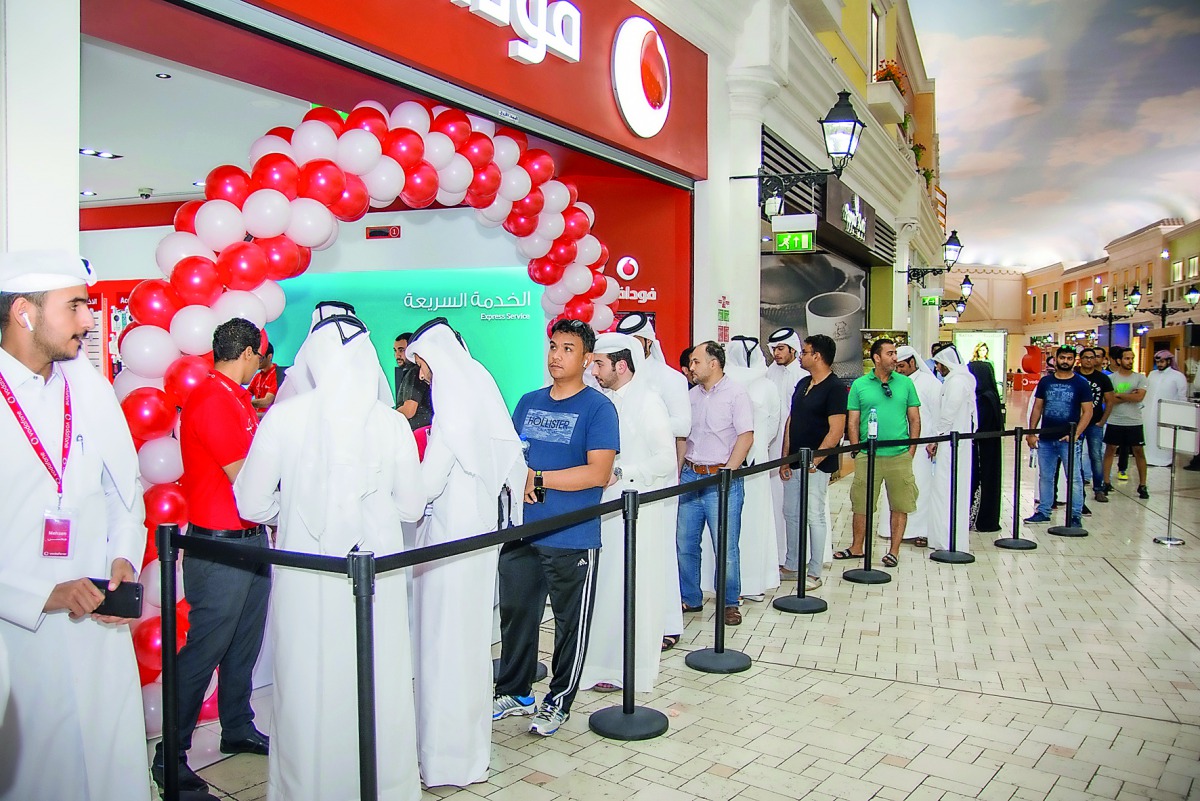 People queue-up outside a Vodafone store located at Villaggio Mall to mark the launch.
