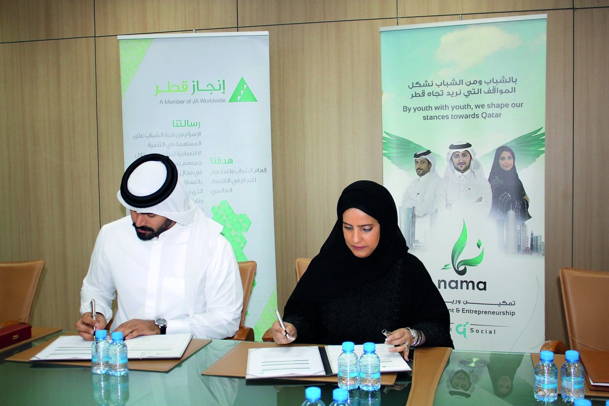 Officials of Injaz Qatar and NAMA Center at the signing of a memorandum of understanding.