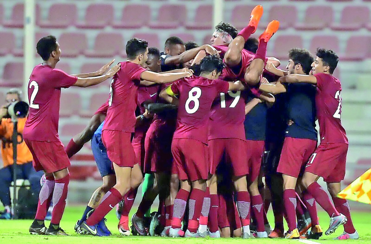 Qatar players celebrate their win over Iraq in Group C match of the AFC U-19 Championship 2018 in Doha yesterday. Qatar qualified for the finals rounds in Indonesia. 