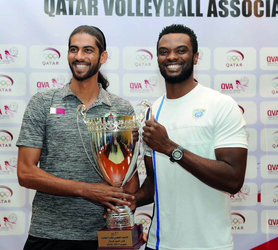 Al Rayyan’s star player Mubarak Dahi (left) and John Chigbo of Police pose with the Super Cup trophy after press conference held at the QVA premises in Doha on the eve of Super Cup clash yesterday. Pictures by: Salim Matramkot/The Peninsula