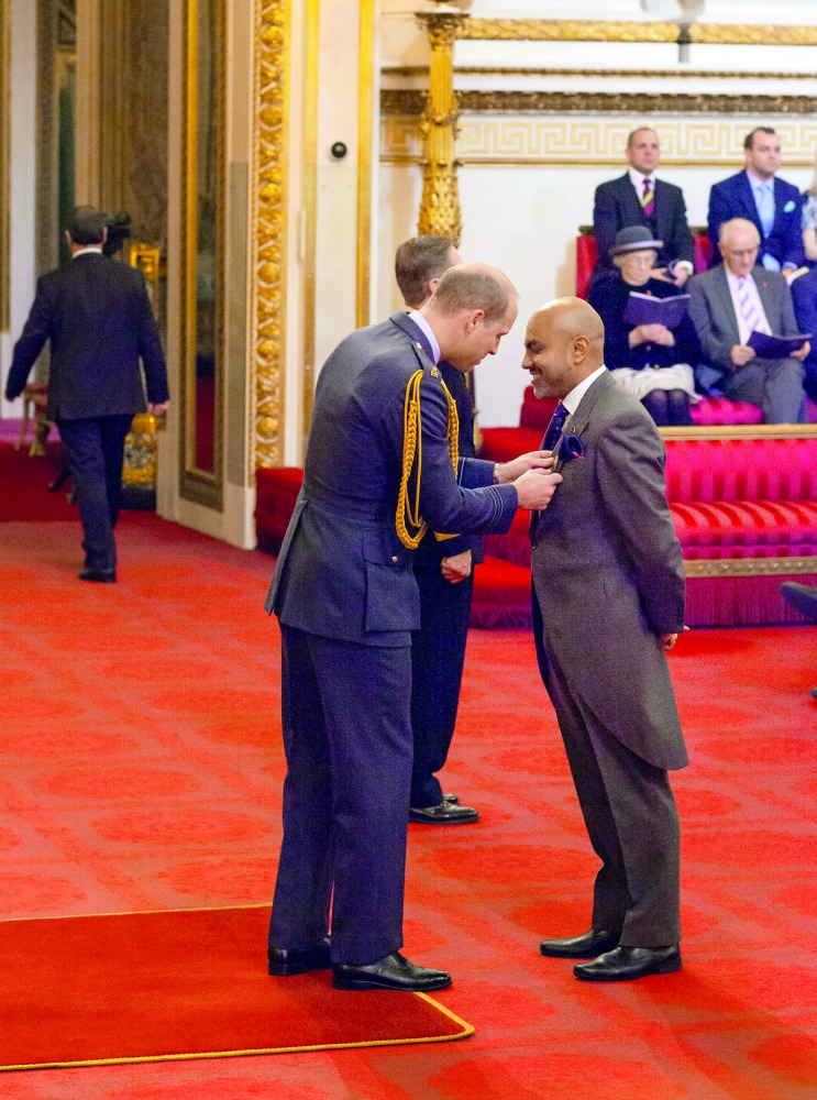 Sultan Choudhury (right) being made an OBE by Prince William, Duke of Cambridge at Buckingham Palace.