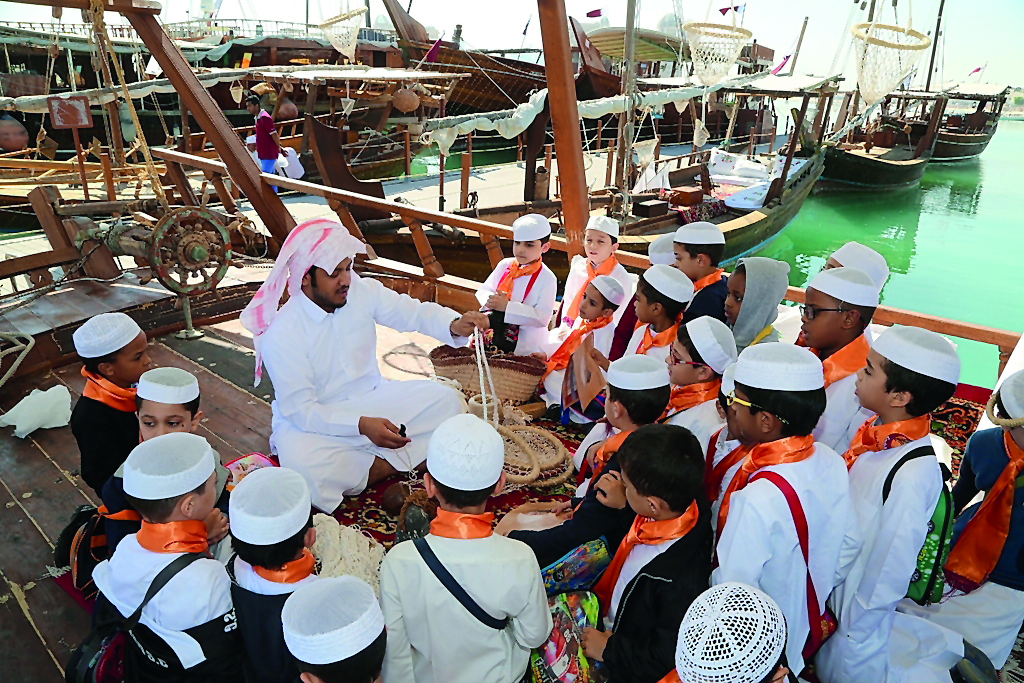 Students observing the tradition Dhow making tradition at the ongoing seventh Katara Traditional Dhow Festival at Katara Beach, yesterday. 