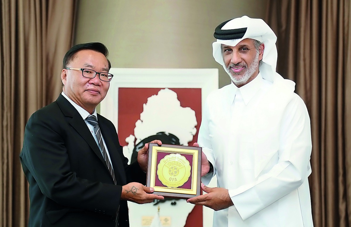 Qatar Football Association (QFA) President, Sheikh Hamad bin Khalifa bin Ahmed Al Thani handing over a memento to President of the Oceania Football Confederation (OFC) David Chung in Doha yesterday.
