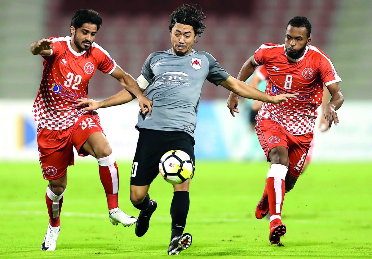 Al Rayyan striker Rodrigo Tabata (centre) is challenged by two Al Arabi players during their QNB Stars League match in Doha on Sunday.