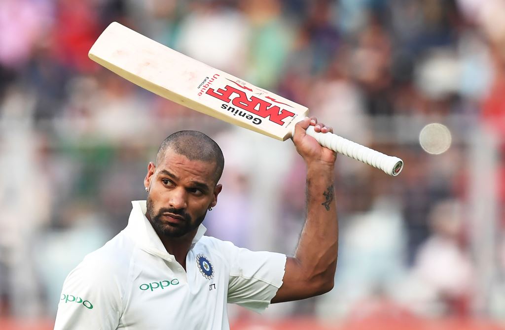 India's cricketer Shikhar Dhawan acknowledges the crowd after loosing his wicket during the fourth day of the first Test between India and Sri Lanka at the Eden Gardens cricket stadium in Kolkata on November 19, 2017. GETTYOUT / AFP / Dibyangshu SARKAR