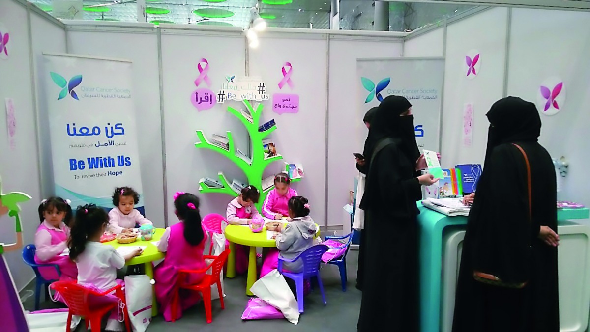 Children engage in various activities at the QCS pavilion.