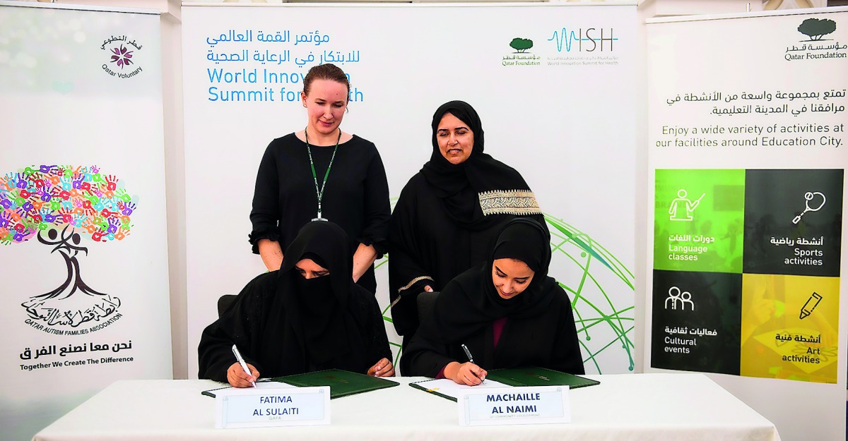 Machaille Al Naimi, President of Community Development, QF, and Fatima Al Sulaiti, Chair, QAFA, at the agreement signing ceremony. Also present was Sultana Afdhal, Acting CEO, WISH.