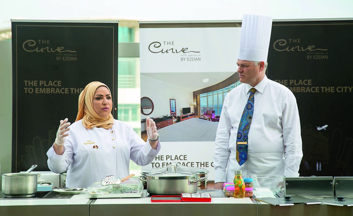 Chef Aisha Al Tamimi and Ambassador Dr Axel Wabenhorst during the cooking event.