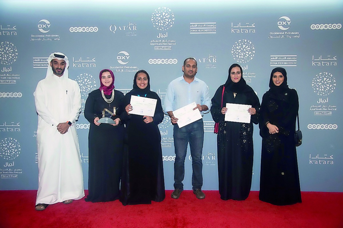 Chief Administrative Officer of Doha Film Institute Abdulla Jassim Al Mosallam (left), CEO of Doha Film Institute Fatma Al Remaihi (right) with award winners Nada Bedair, Rawda Al Thani, Nibu Vasudevan and Amal Al Muftah at the award ceremony during the A