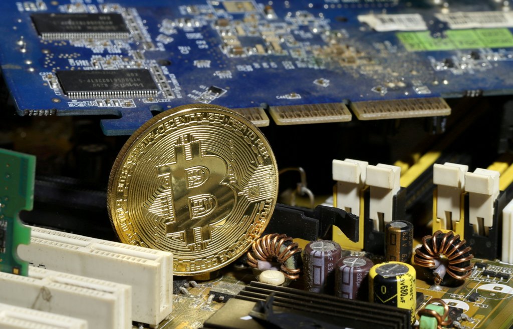 A copy of bitcoin standing on PC motherboard is seen in this illustration picture, October 26, 2017. REUTERS/Dado Ruvic/File Photo