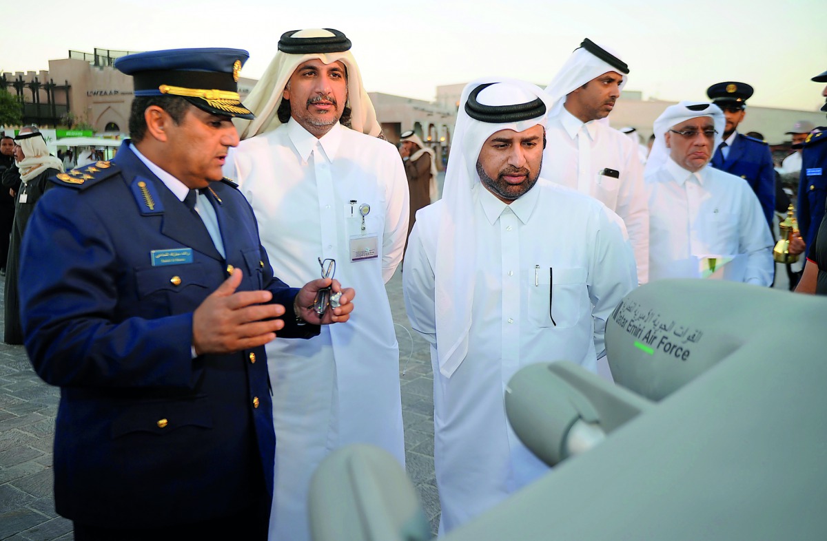 Dr Khalid bin Ibrahim Al Sulaiti (third left), General Manager of Katara, and Brig. Gen. Rashid bin Mubarak Al Mannai (left), from Qatar Emiri Air Force, during the opening of National Day celebrations at Katara yesterday. Pic: Abdul Basit / The Peninsula