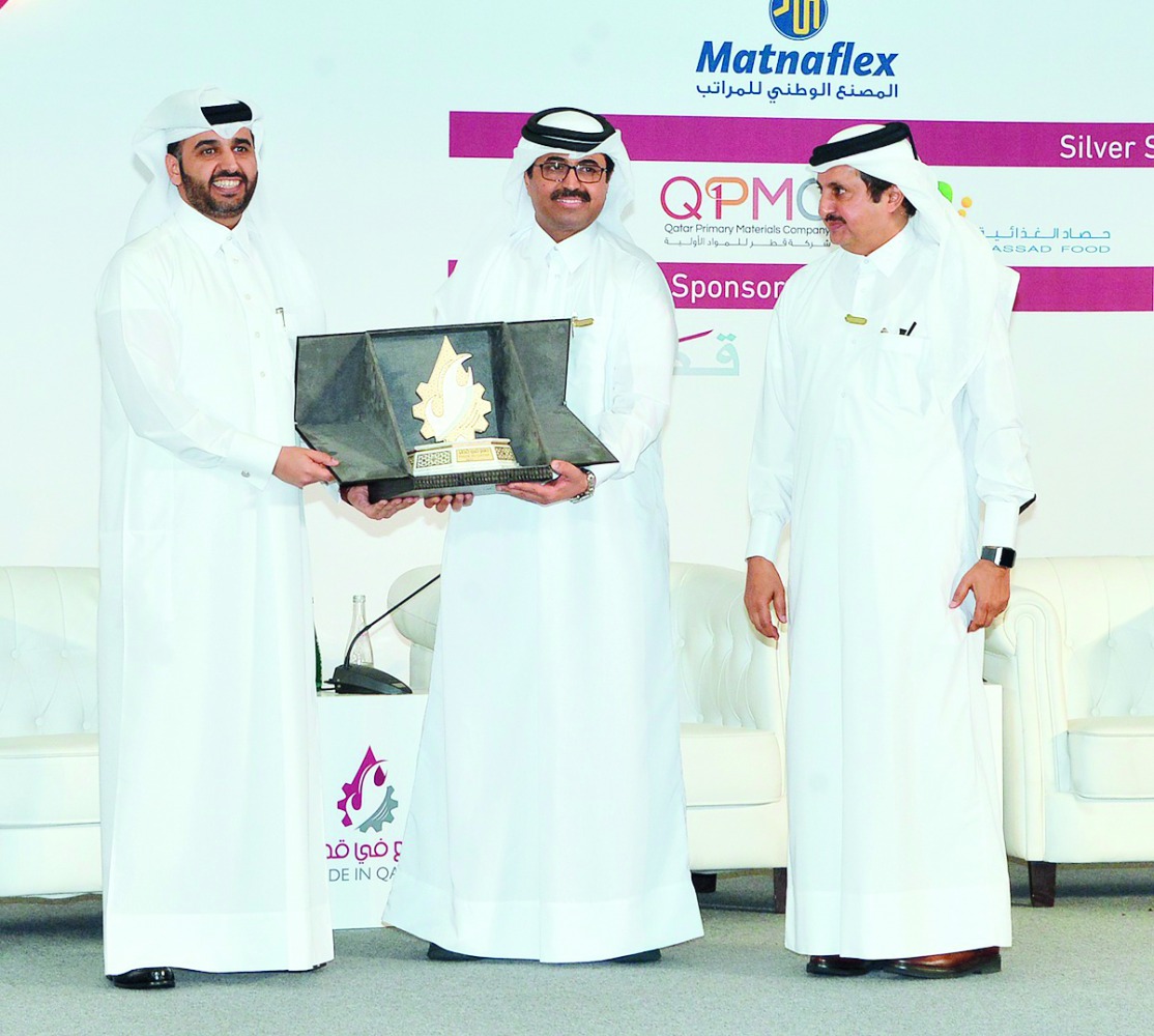H E Dr Mohammed bin Saleh Al Sada (centre), Minister of Energy and Industry presenting a memento to Abdulaziz Al Khalifa (left), CEO of Qatar Development Bank, on the sidelines of ‘Made in Qatar’ expo, as Sheikh Khalifa bin Jassim Al Thani, Chairman of Qa