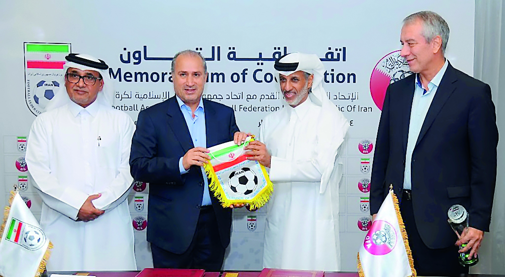 Sheikh Hamad bin Khalifa bin Ahmed Al Thani, President of the QFA and Mehdi Taj, President of the IFA along with other officials during the cooperation agreement signing ceremony at Al Bidda Tower in Doha on Thursday. 