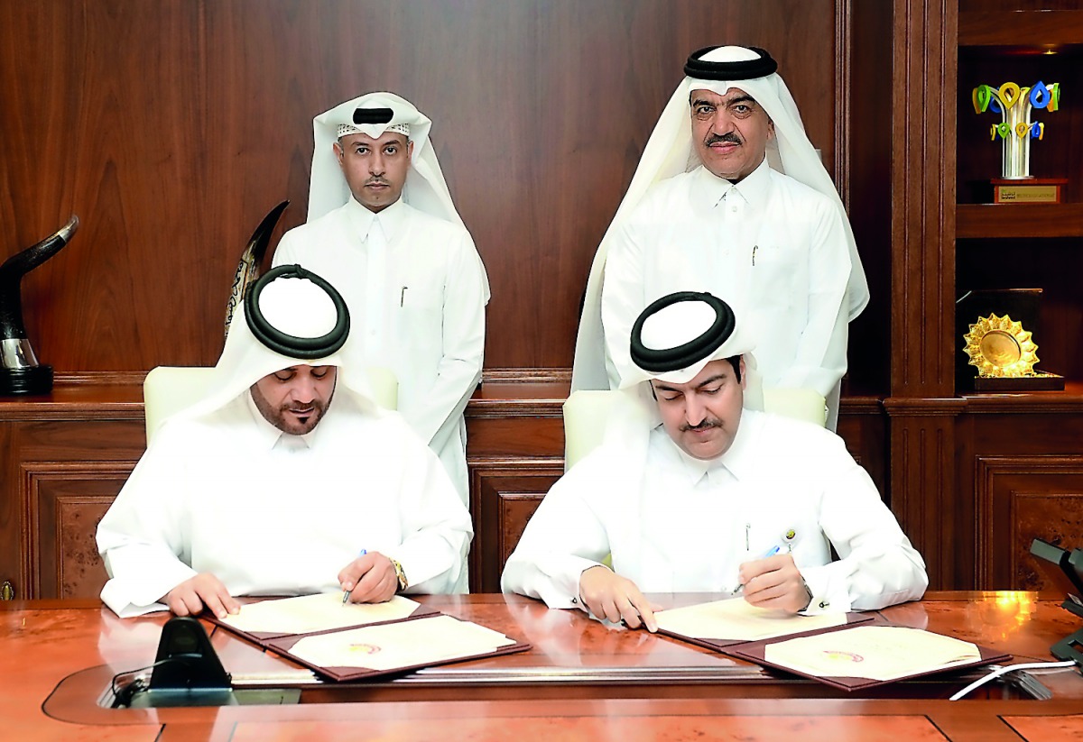 The Minister of Municipality and Environment, H E Mohamed bin Abdullah Al Rumaihi (right),  and Minister of Administrative Development, Labour and Social Affairs H E Dr Issa bin Saad Al Jafali Al Nuaimi ((left) witnessing the signing ceremony at the headq