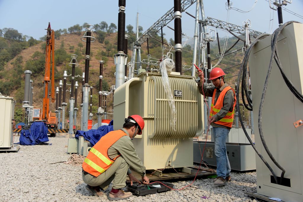This photograph taken on November 1, 2017, shows Chinese engineers working on a power distribution point of the Neelum-Jhelum Hydropower Project in Chattar Klass on the outskirts of Muzaffarabad, the capital of Pakistan-administered Kashmir.  AFP / SAJJAD