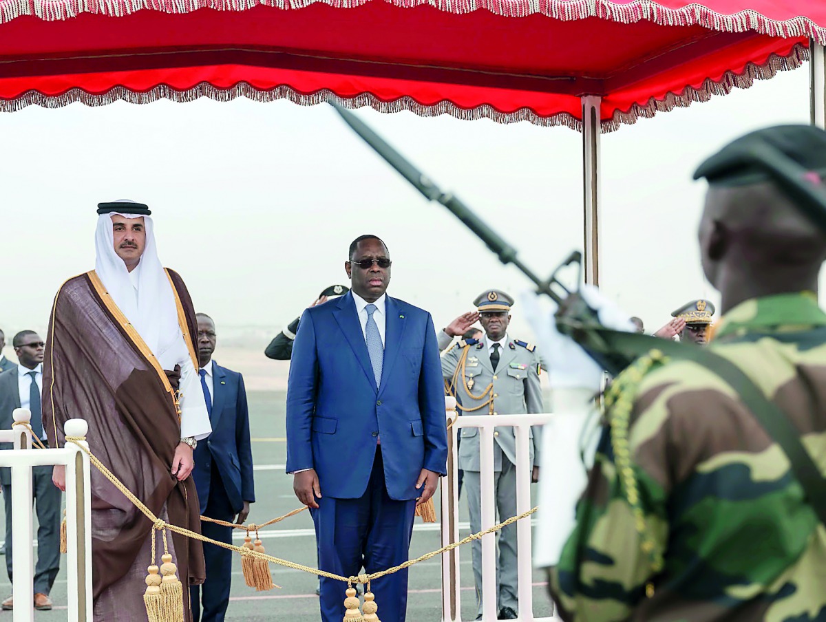 Emir H H Sheikh Tamim bin Hamad Al Thani receiving the guard of honour upon his arrival in Dakar, Senegal, yesterday.