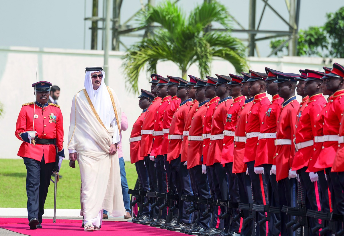 Emir H H Sheikh Tamim bin Hamad Al Thani reviewing the Guard of Honor in Accra yesterday. 