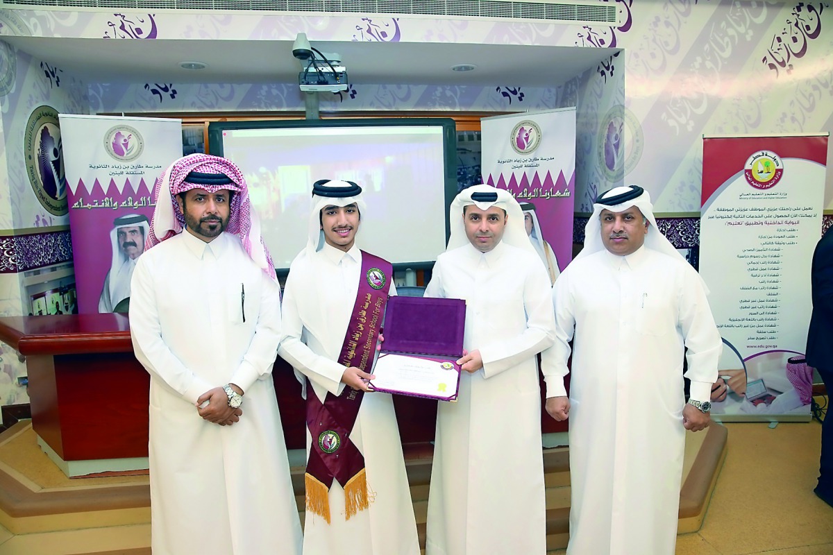 Minister of Education and Higher Education H E Dr Mohammed Abdul Wahed Ali Al Hammadi with  student Abdullah Khaled Al Kaabi in the presence of his guardian and the head of the school.