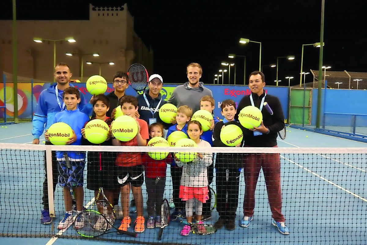 Bosnian tennis player Mirza Basic poses  for a photograph with young participants at the annual kids tennis clinic co-hosted by ExxonMobil Qatar and Qatar Tennis Federation yesterday.