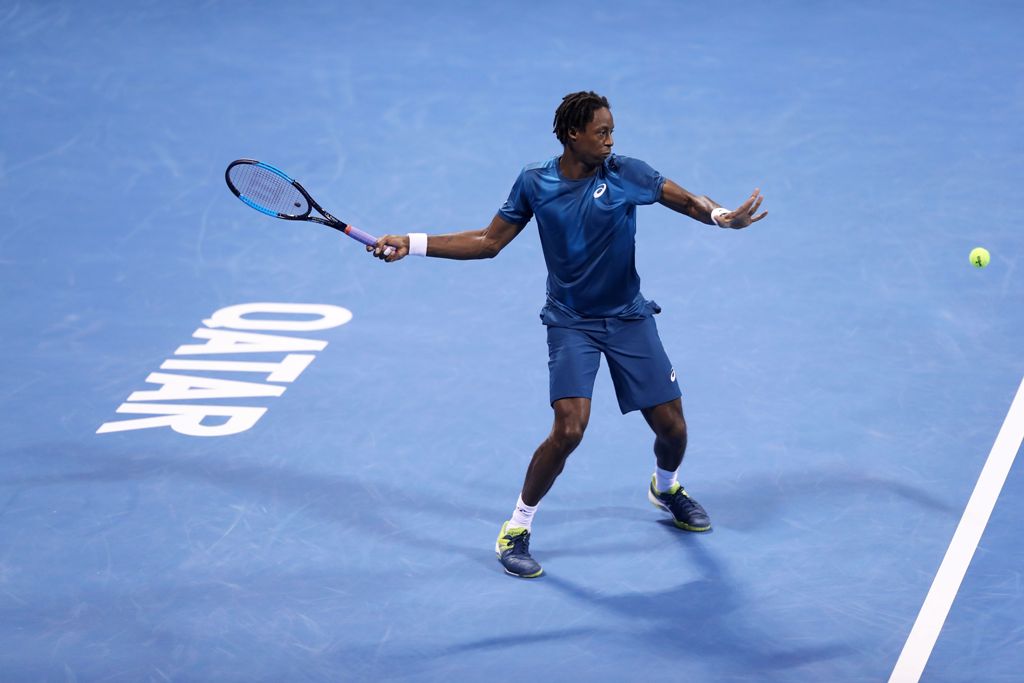 France's Gael Monfils returns the ball to Italy's Paolo Lorenzi during the first round of the ATP Qatar Open tennis competition in Doha on January 2, 2018. / AFP / KARIM JAAFAR
