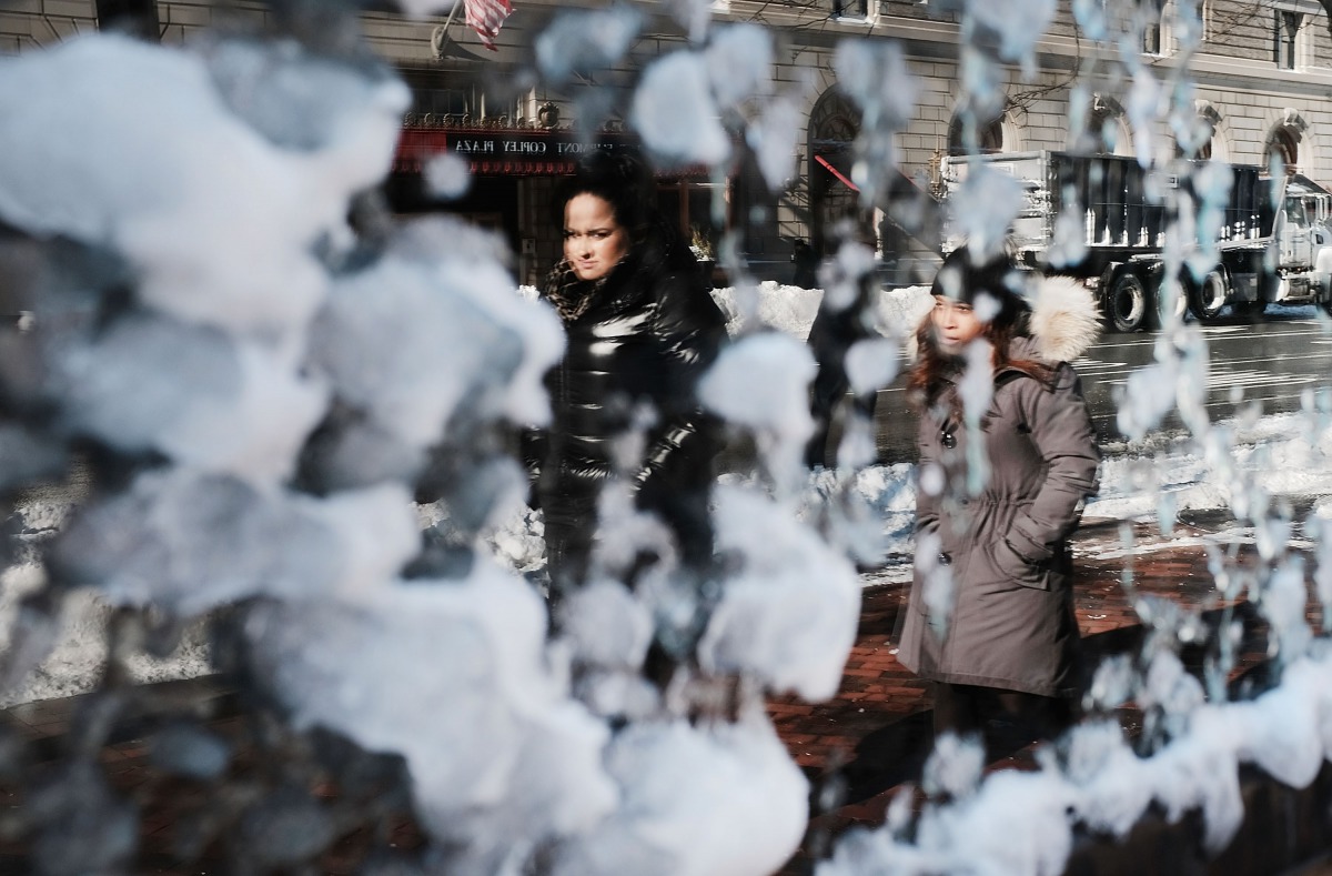 People are reflected in a frozen window the morning after a massive winter storm on January 5, 2018 in Boston, United States. Schools and businesses throughout the Boston area get back to work today after the city received over a foot of snow during a fas