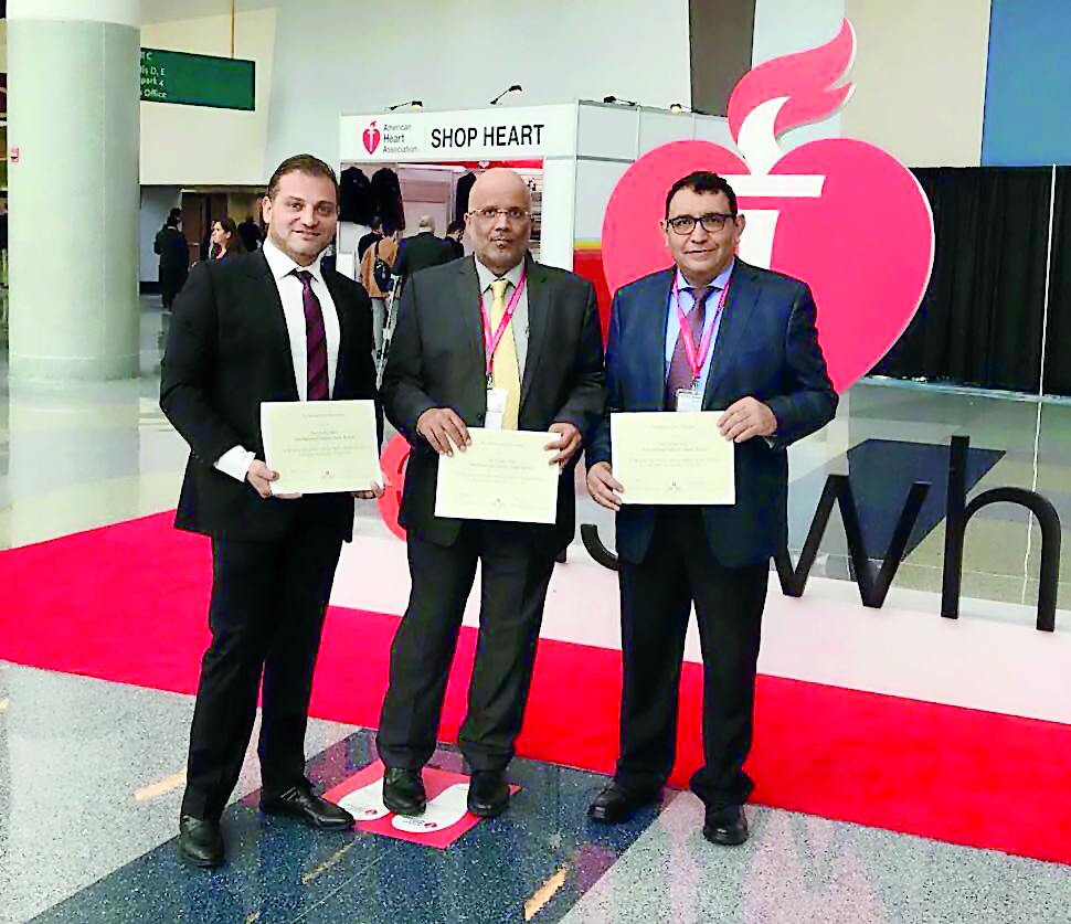 Dr Charbel Abi Khalil, Dr Jassim Al Suwaidi and Dr Nidal Assad with the award.
