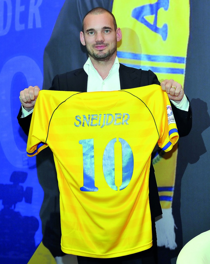 Dutch star Wesley Sneijder poses with his new Al Gharafa jersey at his unveiling for the QSL club yesterday.  Picture by Kammutty VP/The Peninsula