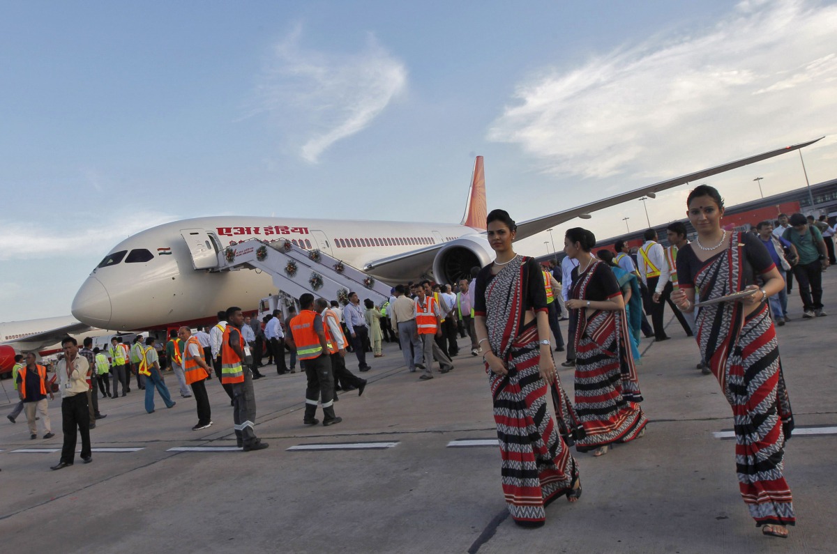 Air hostesses walk next to the parked Air India Boeing 787-800 Dreamliner upon its arrival at the airport in New Delhi, September 8, 2012. (Reuters / Mansi Thapliyal) 