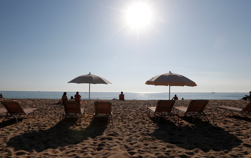 People sunbathe on a hot day in Barceloneta beach in Barcelona, Spain, Oct. 15, 2017. REUTERS/Gonzalo Fuentes/File Photo
