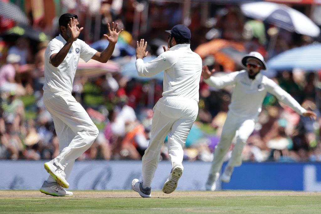 India's bowler Ravichandran Ashwin (L) celebrates the dismissal of South Africa's Aiden Markram (not in picture) during the first day of the second Test cricket match between South Africa and India at Supersport cricket ground on January 13, 2018 in Centu