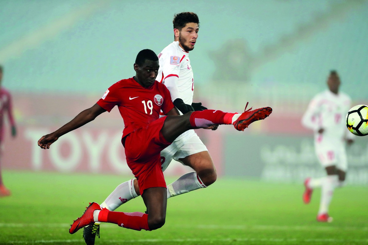 Qatari forward Almoez Ali kicks the ball during yesterday’s AFC U-23 Championship quarter-final match against Palestine in Changzhou, China.