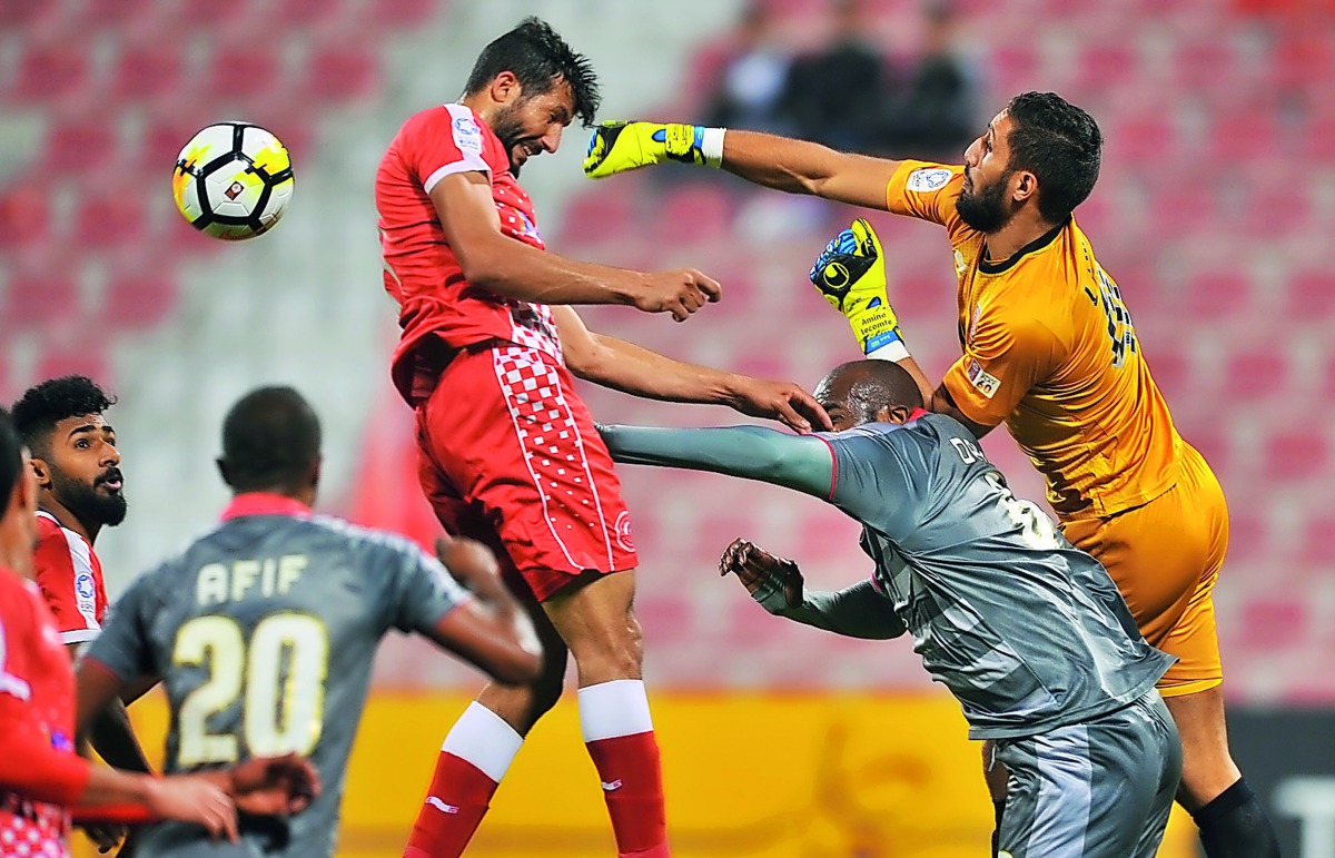 Al Duhail  goalkeeper Lecoumet Kloud punches the ball to safety during their QNB Stars League match against Al Arabi at Al Arabi Stadium in Doha yesterday.  Pic: Baher Amin/The Peninsula