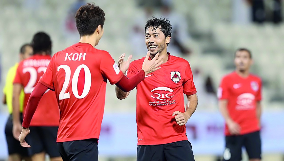 Al Rayyan  striker Rodrigo Tabata (right) celebrates with team-mate Koh after scoring a goal.