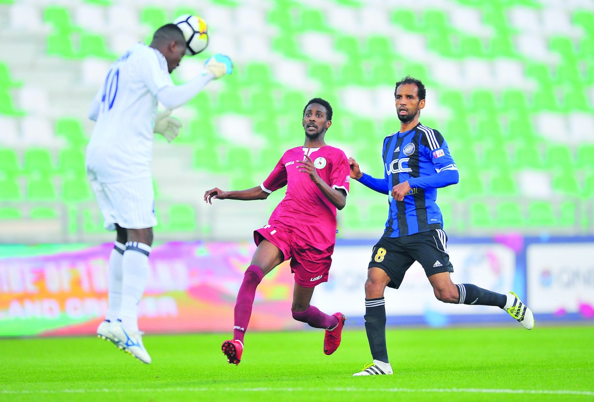 Hassan Idress Al Sailiya goalkeeper heads the ball away from Markhiya player Mohamed Salah during their QNB Stars League match at Al Ahli Stadium yesterday. Pic: Baher Amin/The Peninsula