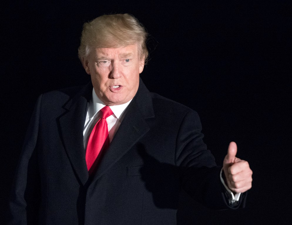 United States President Donald J. Trump gestures after answering a reporter's question as he returns to the White House in Washington, DC, USA, 26 January 2018, after attending the World Economic Forum in Davos, Switzerland. EPA/RON SACHS / POOL