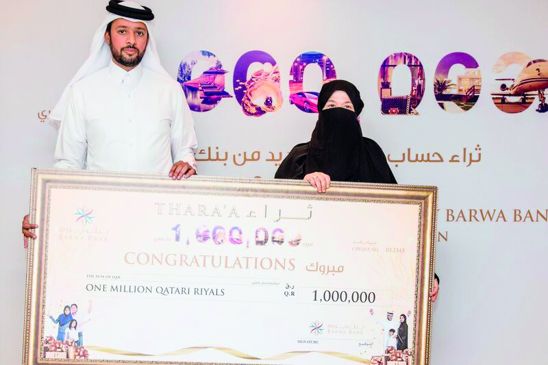 Khalid Al Subeai, Group Chief Executive Officer at Barwa Bank, with QR1m prize winner Amal Ghalayini.