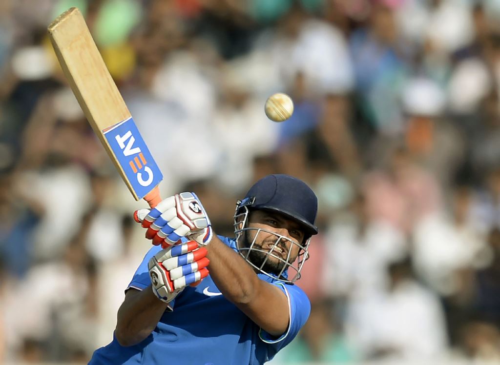 (FILES) This file photo taken on January 12, 2017 shows Indian batsman Suresh Raina playing a shot during the second warm-up one day cricket match between India A and England XI at the Cricket Club of India (CCI) stadium in Mumbai. AFP / Punit Paranjpe 