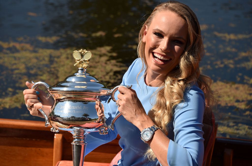 Denmark's Caroline Wozniacki arrives in a gondola with the winner's trophy for a photocall at the Royal Botanical Gardens in Melbourne, a day after beating Romania's Simona Halep in their women's singles final match at the Australian Open tennis tournamen
