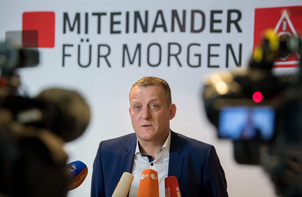 German district manager of IG Metall (Industrial Union of Metalworkers), Roman Zitzelsberger talks to the press before the fourth round of negociations between representatives of IG Metall and employers on January 24, 2018 in Boeblingen.  AFP / DPA / Seba