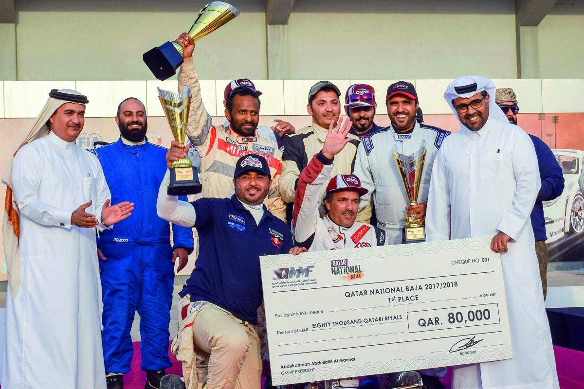 Qatar Baja winners pose with their trophies along with Qatar Motor and Motorcycle Federation (QMMF) President Abdulrahman Al Mannai applauds. RIGHT: Ahmed Allouh displays his trophy after winning the Qatar National Baja title at Losail International Circu