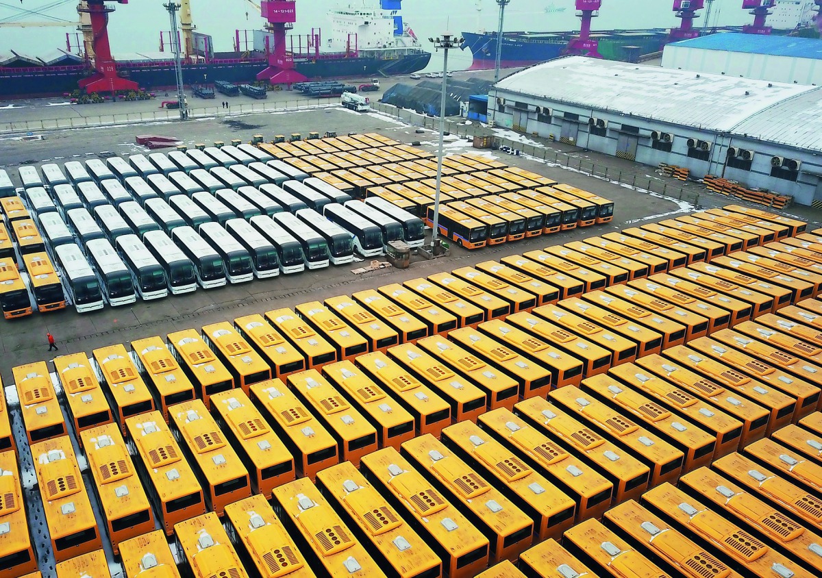 This aerial view shows new buses lined up for export at a port in Lianyungang, east China's Jiangsu province on January 31, 2018. AFP
