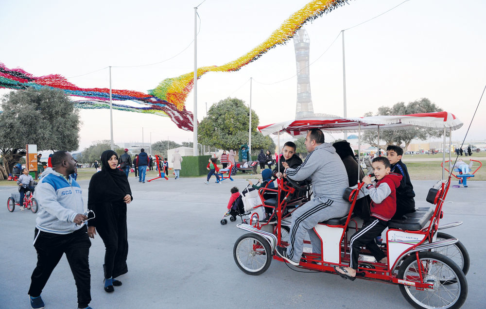 People enjoying cool weather at the Aspire Park in Doha, yesterday. Cold winds have continued to bring the mercury down for the last couple of days. Salim Matramkot/The Peninsula
