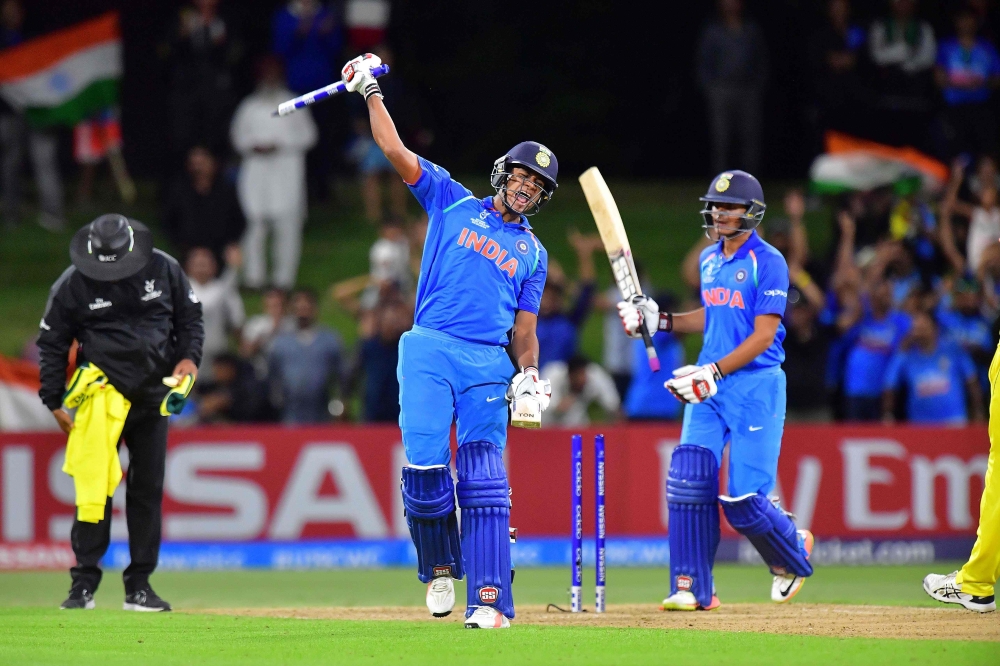 India's Manjot Kalra (C) celebrates the team's victory with teammate Harvik Desai during the U19 cricket World Cup final match between India and Australia at Bay Oval in Mount Maunganui on February 3, 2018. AFP / Marty MELVILLE