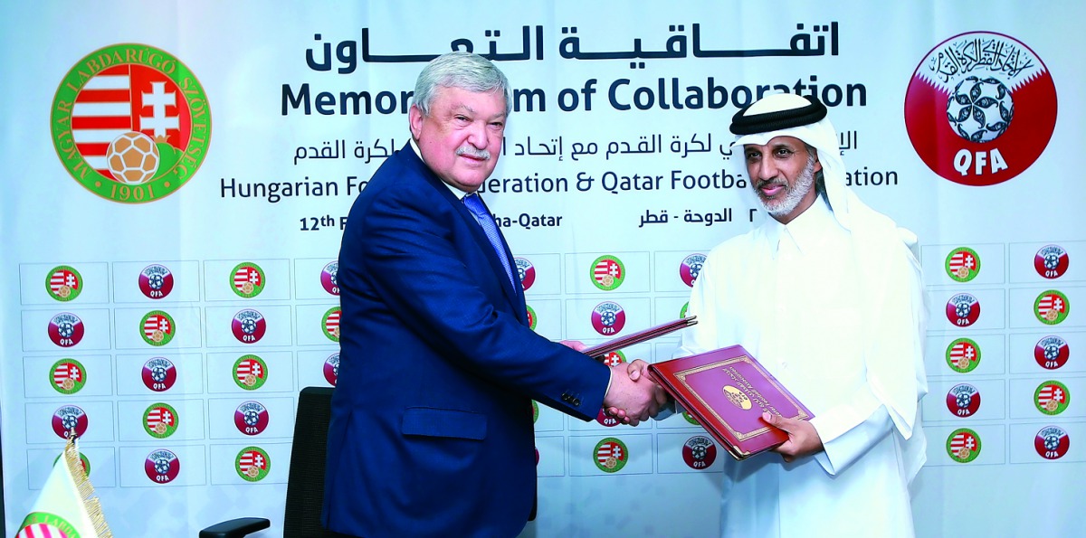 Sheikh Hamad bin Khalifa bin Ahmed Al Thani, President of Qatar Football  Association and  Sándor Csányi, President of Hungarian Football Federation excahnge documents during the signing ceremony.