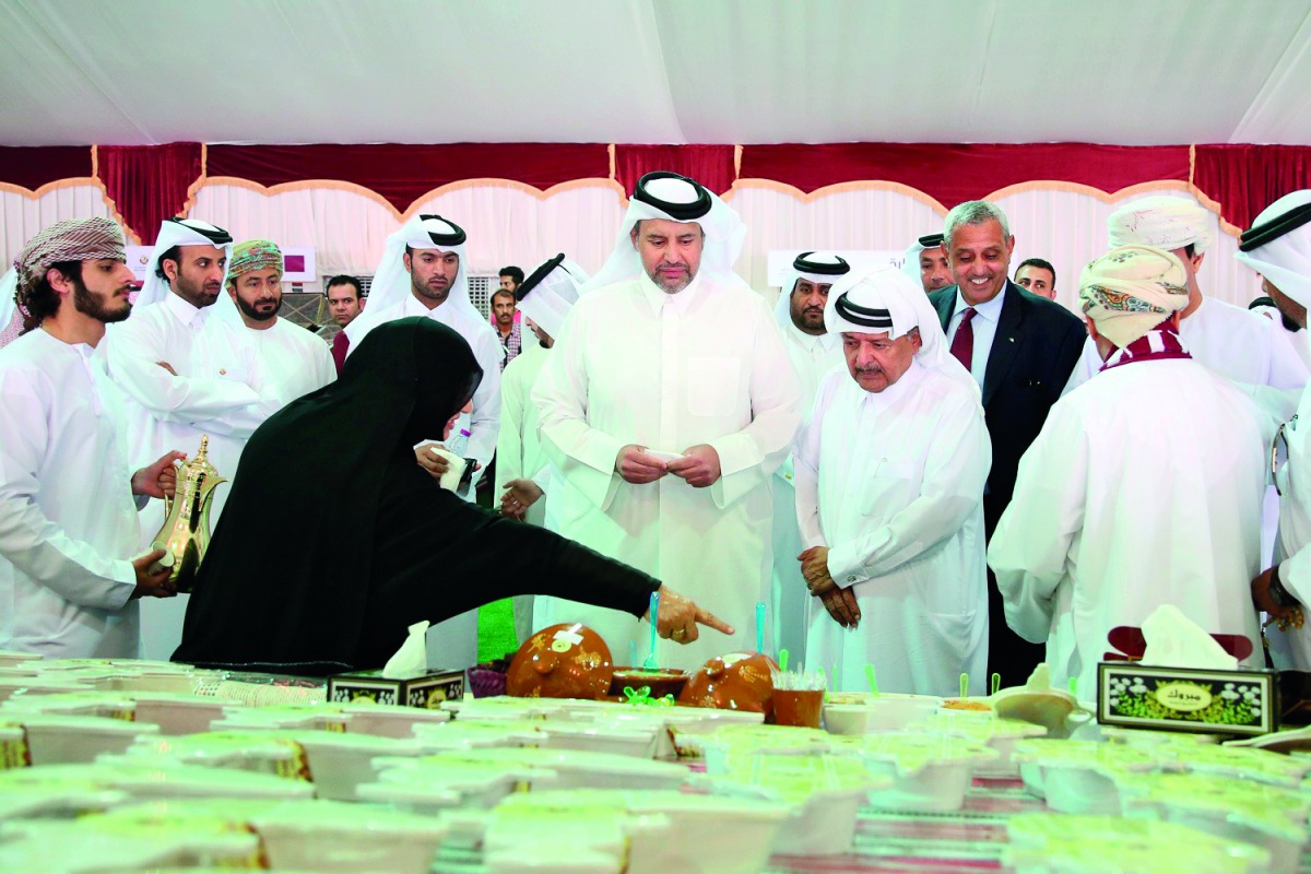 Minister of Economy and Commerce, H E Sheikh Ahmed bin Jassim bin Mohammed Al Thani, visiting a stall after inaugurating the Seasonal Dates Market at Souq Waqif, yesterday.