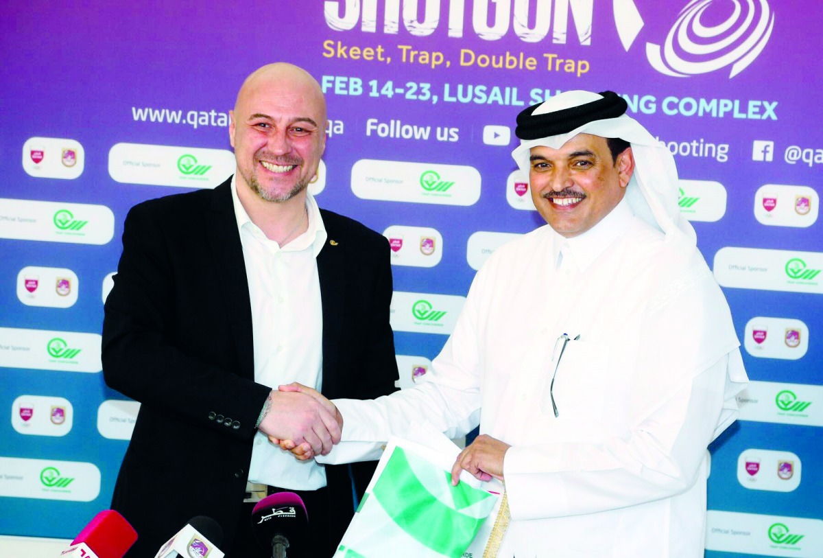 Qatar Shooting and Archery Association President Ali Mohammed Al Kuwari and Trap Concaverde shooting range official Ivano exchange mementos.