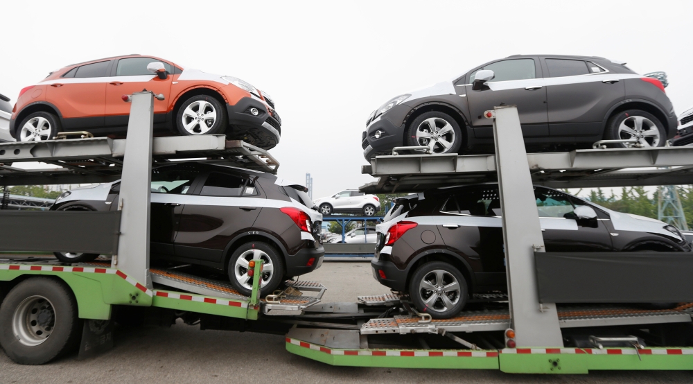 Cars made by GM Korea are seen on trucks in a yard of GM Korea's Bupyeong plant before they are transported to a port for export, in Incheon, west of Seoul August 9, 2013. Reuters/Lee Jae-Won
