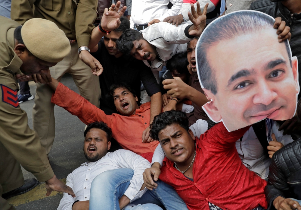 An activist of the youth wing of India's main opposition Congress party holds a cut-out with an image of billionaire jeweller Nirav Modi during a protest in New Delhi, India February 16, 2018. Reuters/Saumya Khandelwal